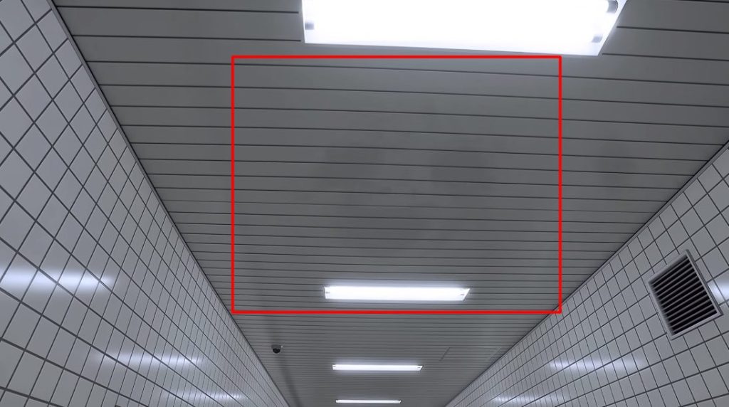The Exit 8 shadowy face in the ceiling
